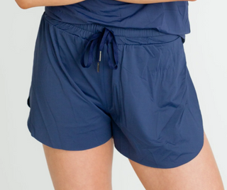 Navy blue drawstring shorts with elastic waistband and lightweight woven fabric