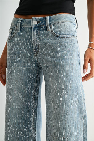 Light blue wide-leg jeans with vertical rows of silver rhinestone studs throughout